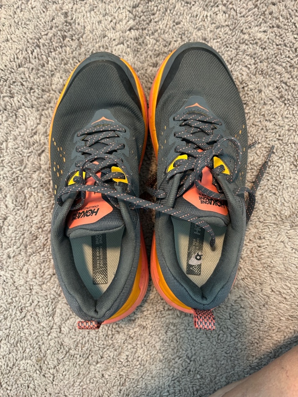 Hoka One One women’s Black Running Sneakers with Orange & Yellow Accents